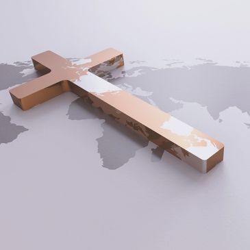 A shiny cross lies on a world map, symbolizing global faith.