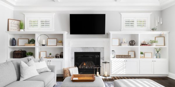 Bright living room with a modern fireplace and built-in shelves.