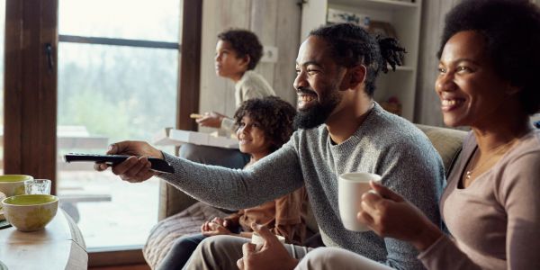 Famille regardant la télévision avec bonheur.