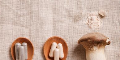 Mushroom with capsules on wooden spoons.