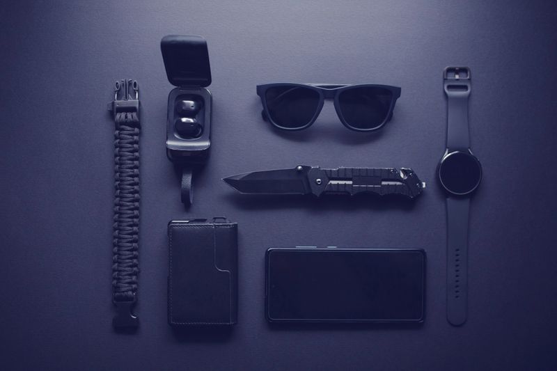 Set of EDC (Every Day Carry) items on dark background