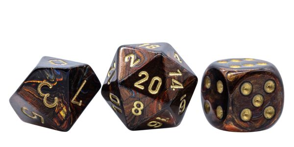Close-up of three marbled gaming dice with gold numbers on white background.