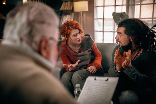 Couple arguing during a session with a counselor.