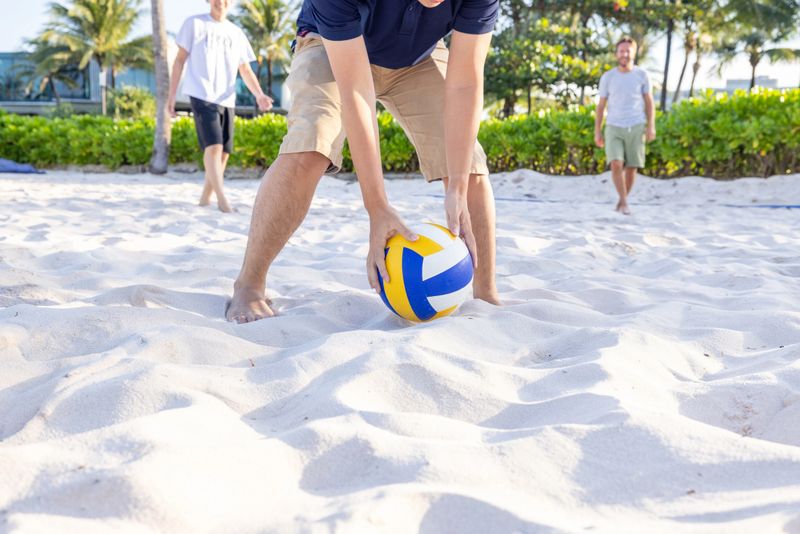 Group of people playing volleyball on the beach