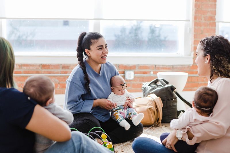 The young adult mother talks to a new friend she met at their small group meeting.