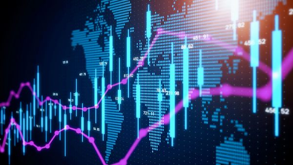 Digital stock market charts with blue candlesticks and pink trend lines over a world map.