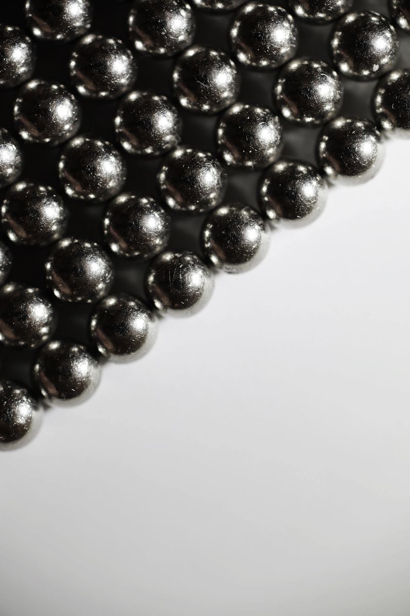 Metal balls close up. Balls of neodymium (magnets). magnetic ball bearing tiling in perfect hexagonal grid