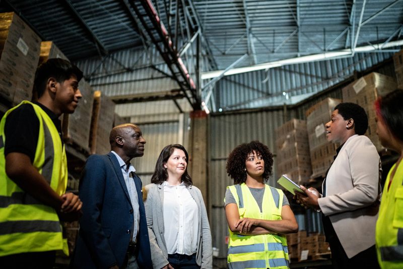 Coworkers in a meeting in a warehouse
