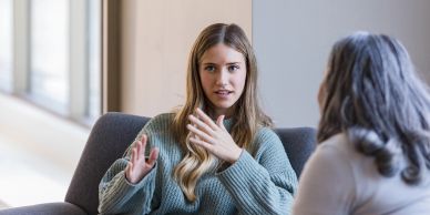 Young woman talking with an older woman.