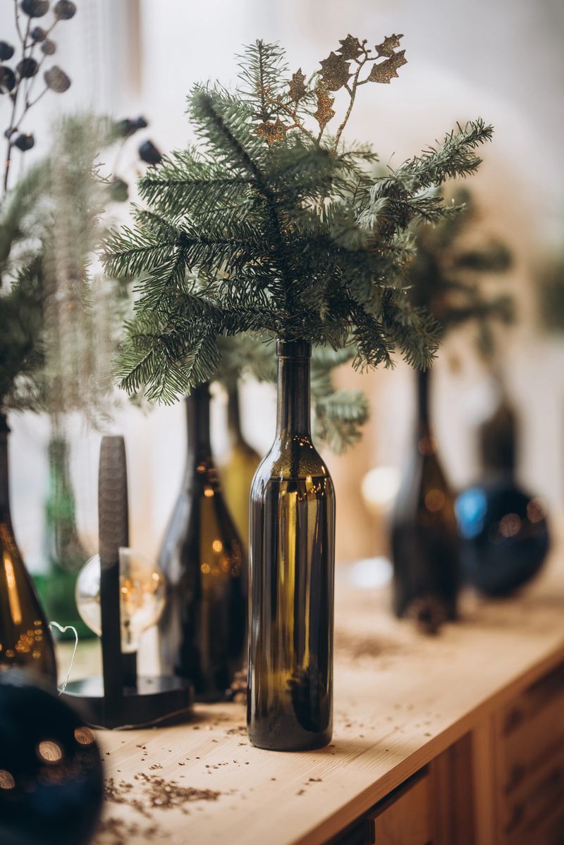 Christmas decorations on the wooden windowsill, spruce branch in the bottle