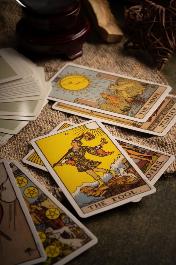 A deck of tarot cards, the fool card showing