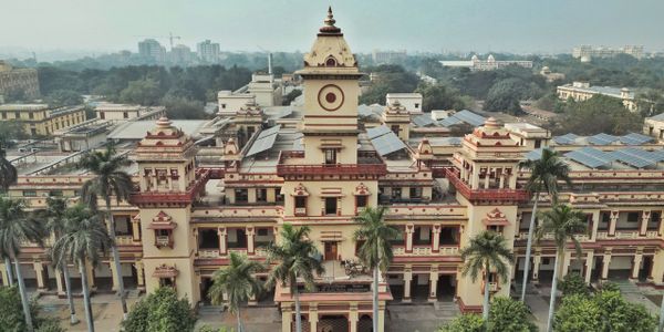 Historic building with ornate architecture and solar panels on the rooftops.