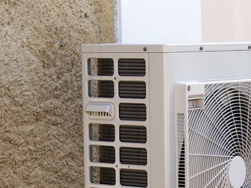 Air source heat pump installed beside a modern home