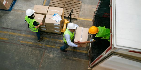 Workers loading boxes into a truck.