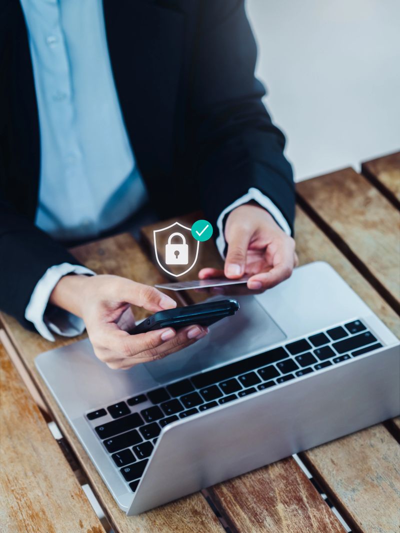 Payment secure, financial transaction security and protection concepts. Virtual digital safety shield with padlock appear while businessperson using credit card and smartphone for online payment.