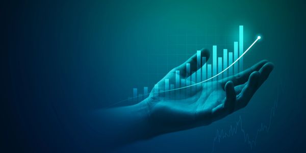 Hand supporting rising bar chart symbolizing growth.