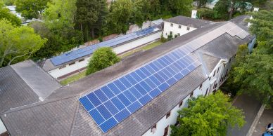 Solar panels installed on a large building rooftop.