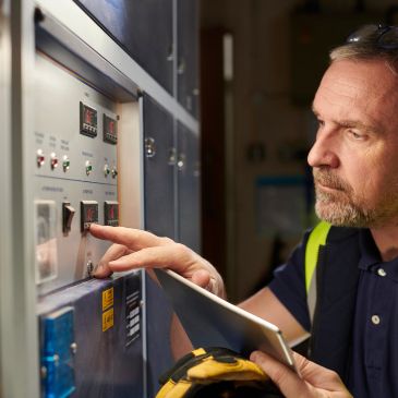 Man operating control panel with focus and precision.