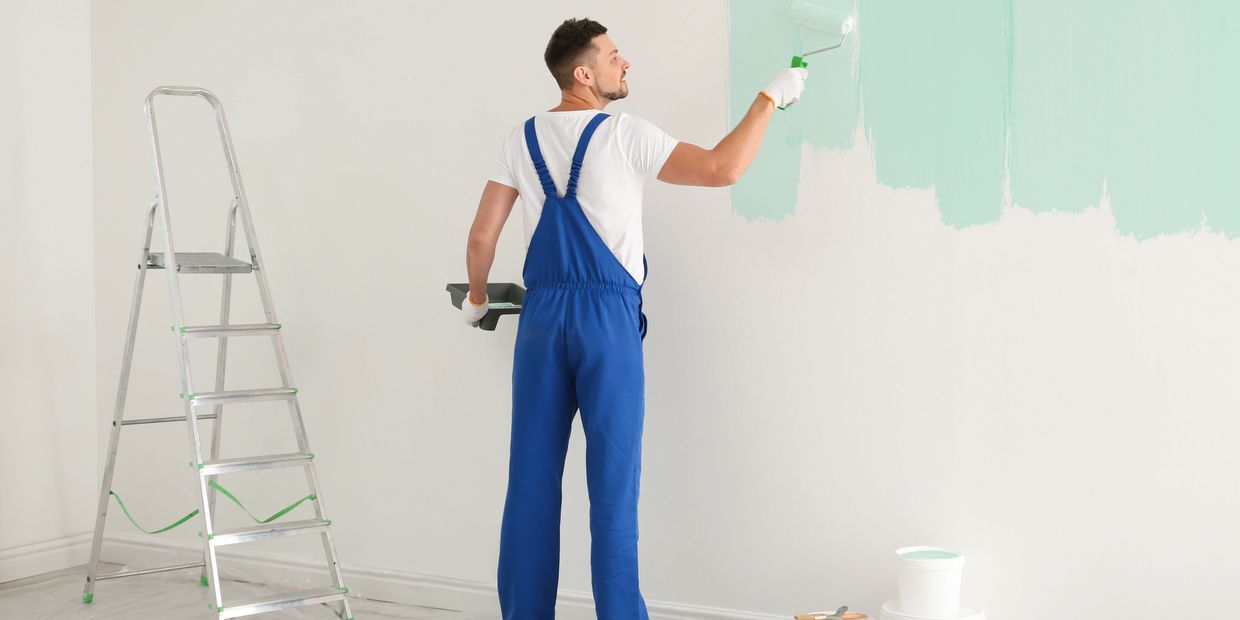 Man painting the wall.