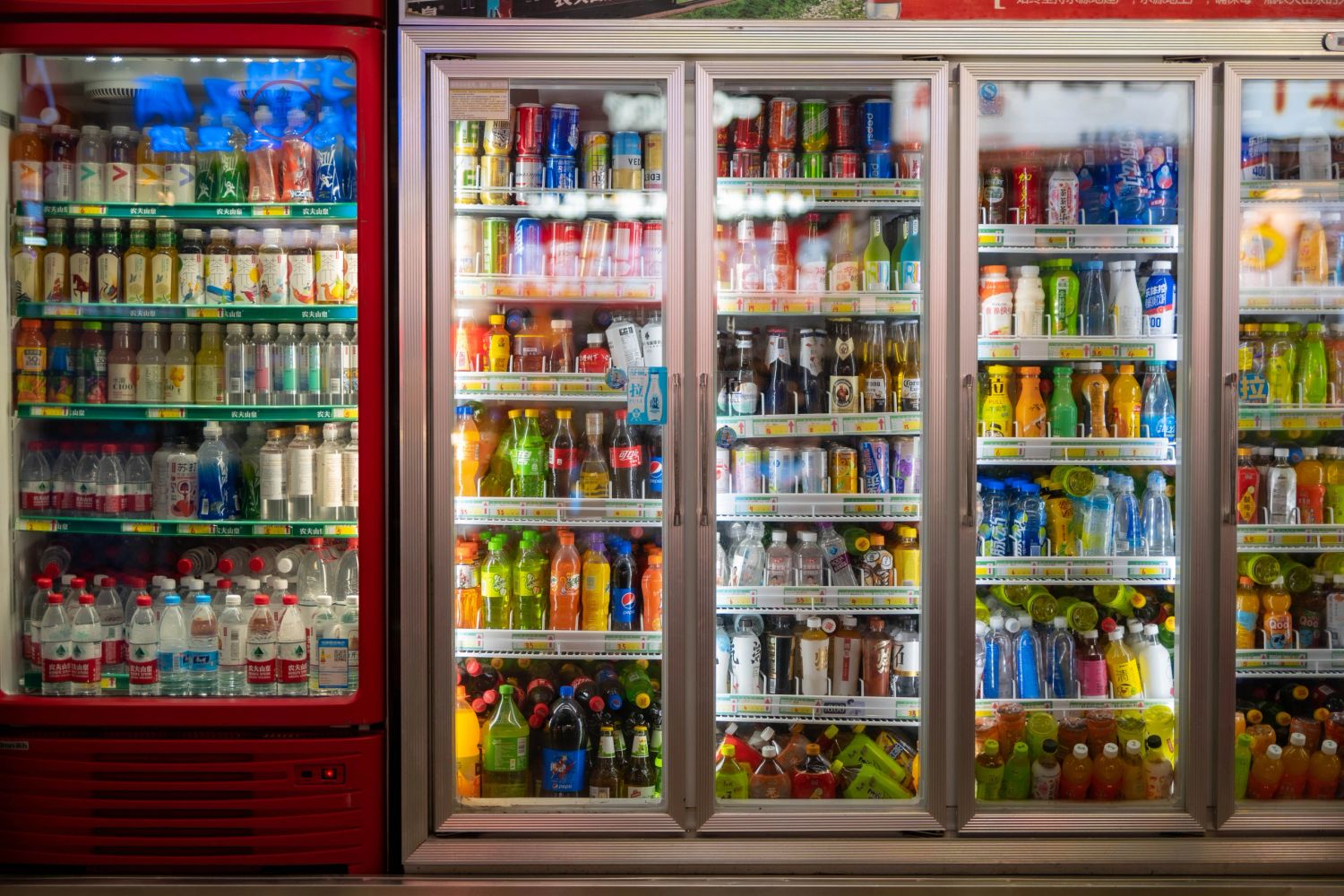 Refrigerators filled with a variety of beverages.