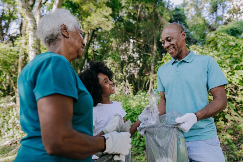 Three generation family picking up garbage in nature