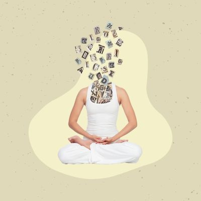 Person meditating with letters replacing their head.