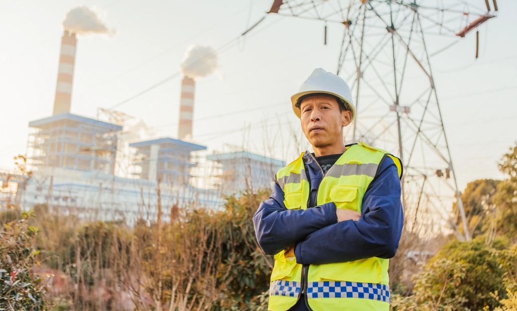 Industrial chimney with smoke, highlighting environmental impact.