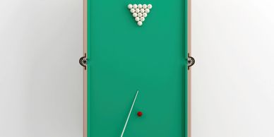 Top-down view of a billiards table with balls arranged.