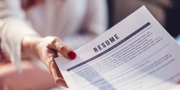 Person reviewing a resume during a job interview.