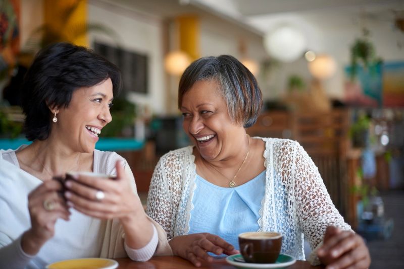 Cafe, friends and senior women with coffee smile, relax and together for quality time, conversation and social chat. Happy, retirement and elderly woman laughing, talking and drinking in restaurant