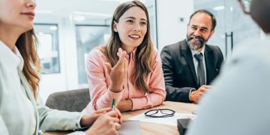 A woman speaking in a business meeting.