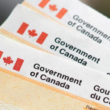 Close-up of Canadian government documents with flags and text.