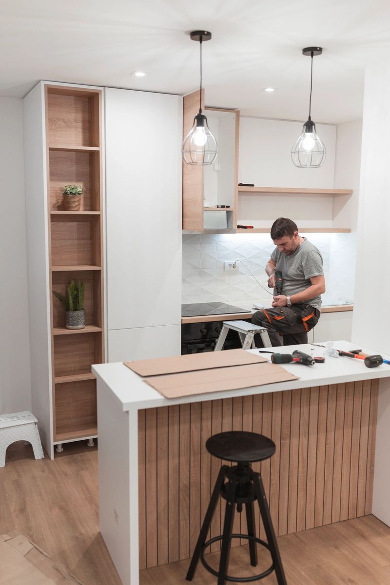 Handyman concentrating on his work in a new kitchen