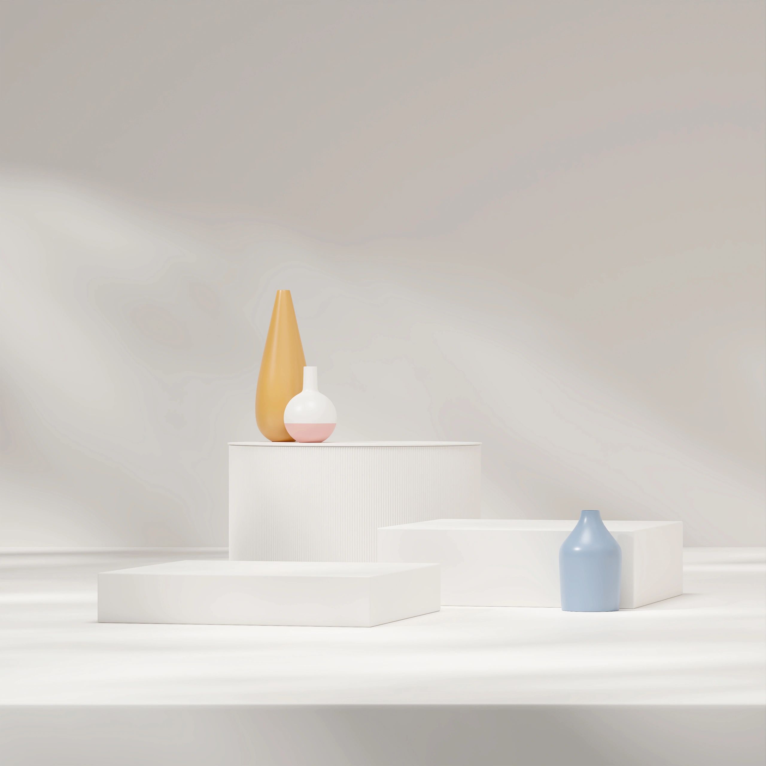 Minimalistic decor with three vases on white platforms.