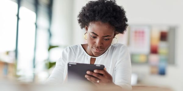 Woman focused on tablet.