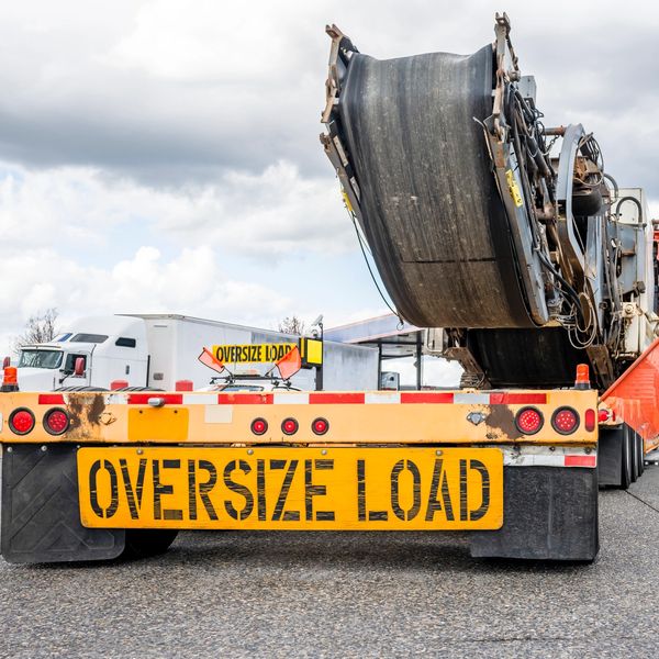Oversize load sign on a flatbed truck.