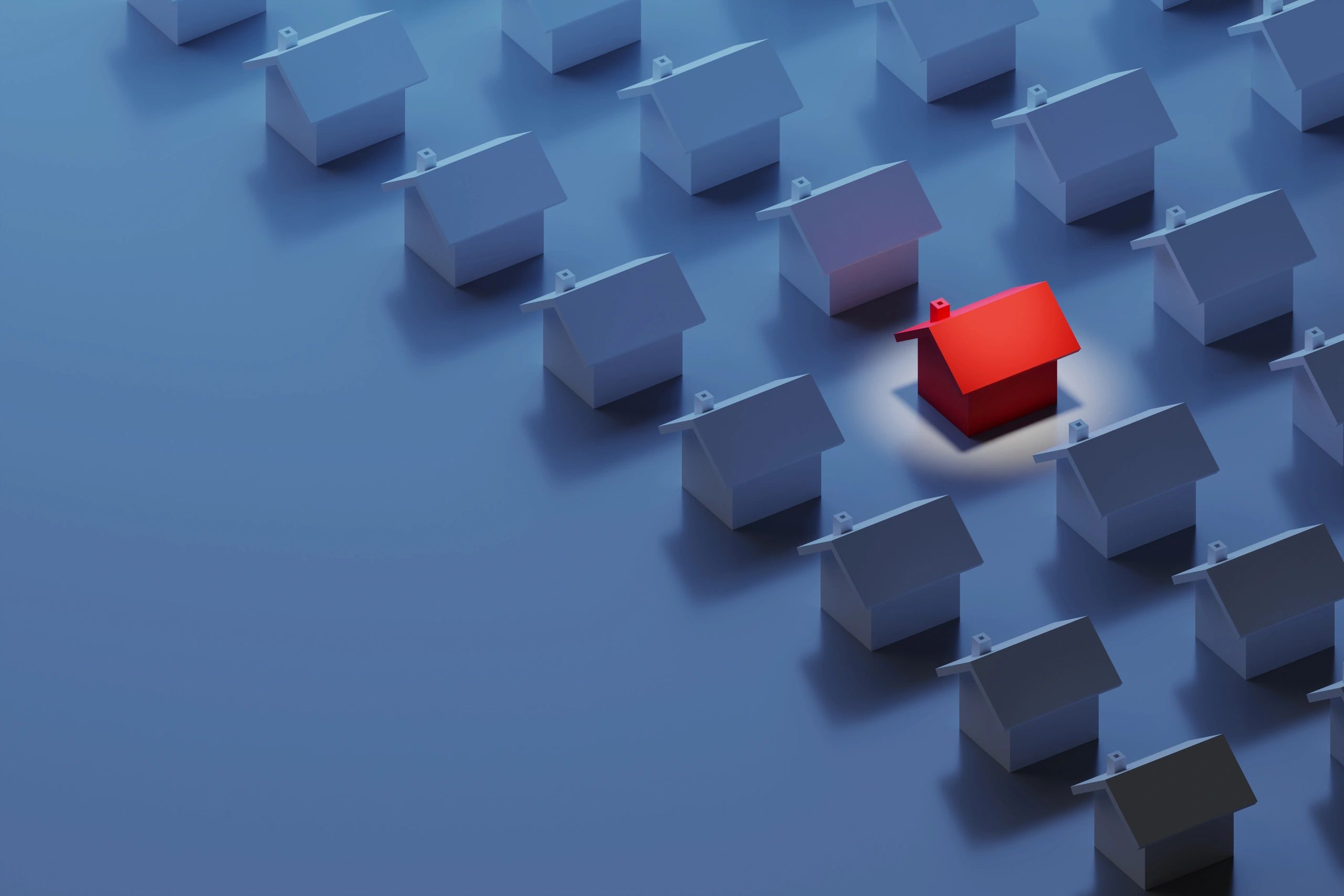 A single red house stands out among many blue houses.