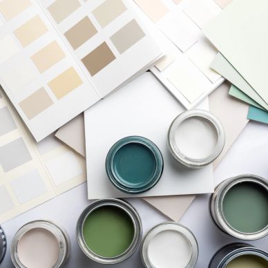 Open paint cans and color swatches arranged on a white surface.