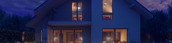 Two views of a house with beige siding and windows under a blue sky.