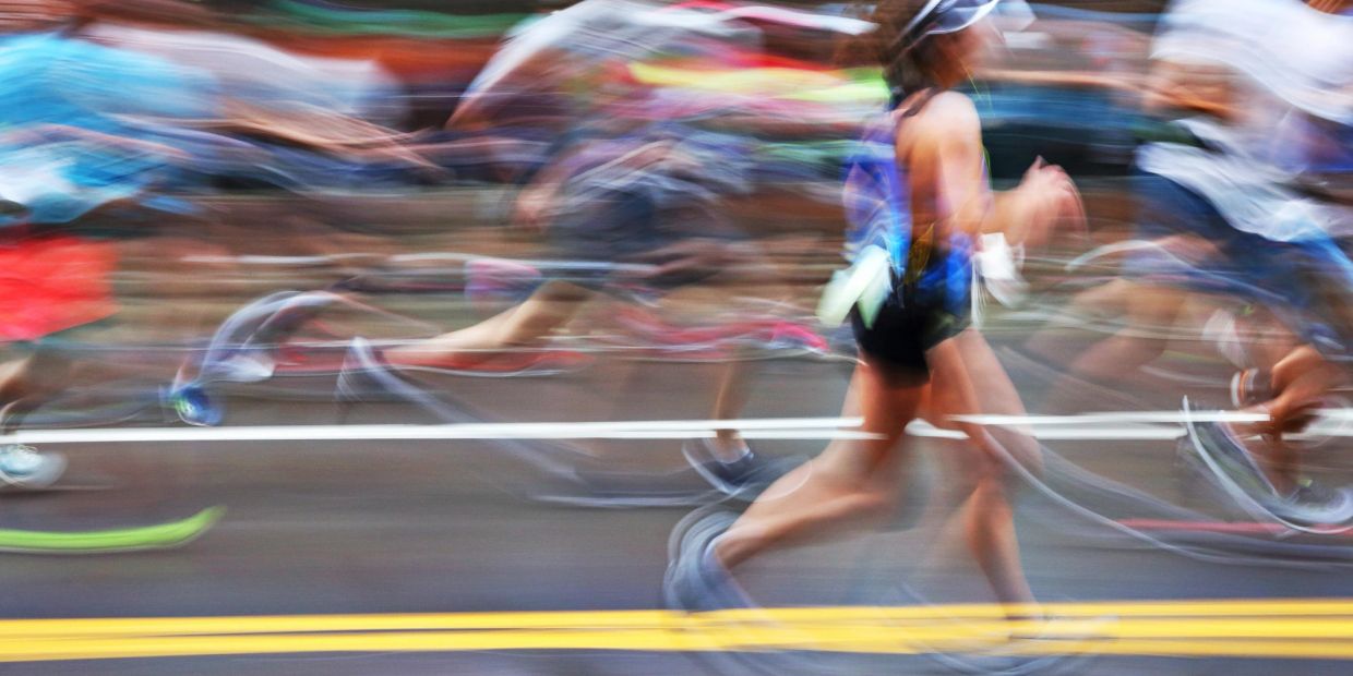 Blurred image of runners in motion during a race.