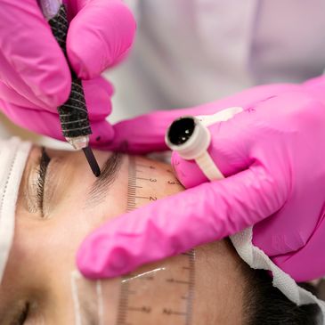 Measuring, planning  permanent makeup eyebrows.
