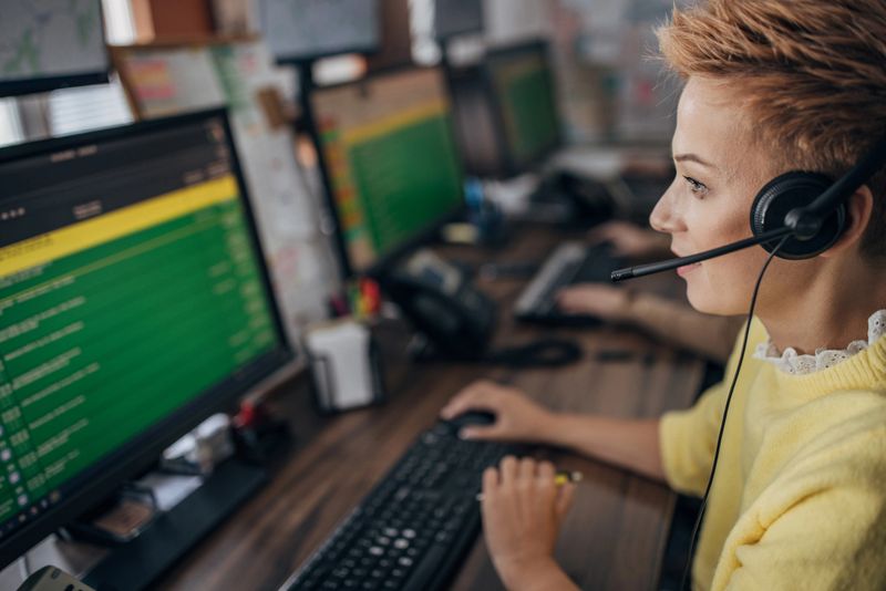 One woman, female taxi service operator with headset working in call center.