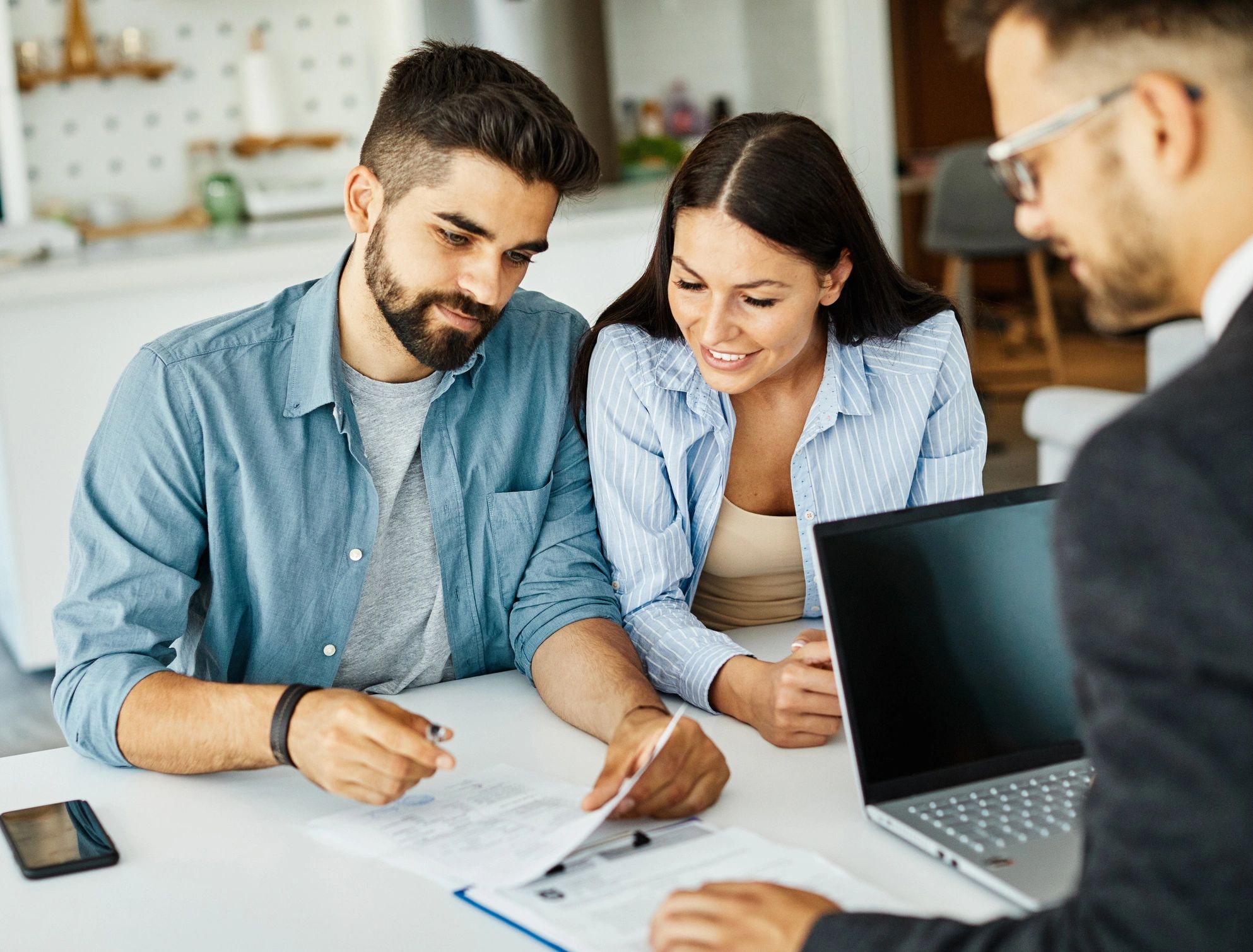 Mortgage broker reviewing home loan documents with clients.
