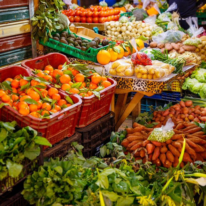 Fresh fruits and vegetables displayed at a colorful market stall.