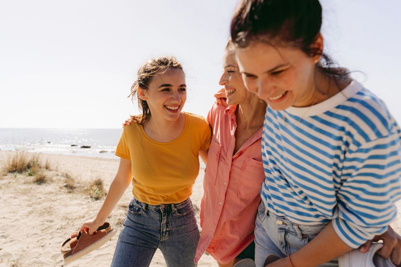 Photo of a couple of female friends having fun on a weekend getaway on local beach