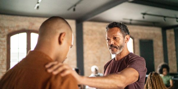 Two men having a serious conversation indoors.