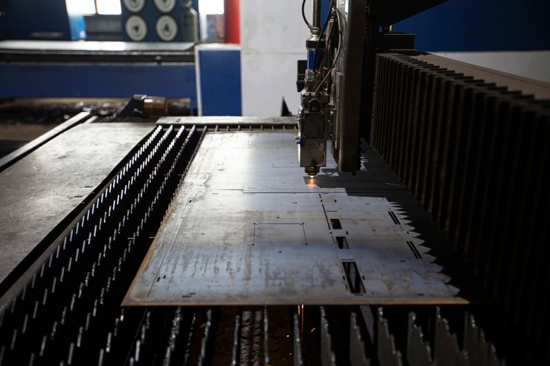 Cutting of metal. Sparks fly from laser.Laser cutting machine working with sheet metal with sparks at factory, plant.