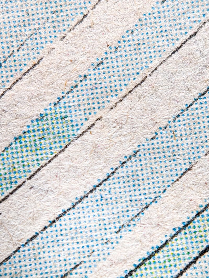 Closeup of a real vintage comic book page with abstract blue dot printing pattern on a paper texture background