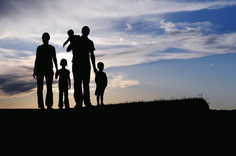 A family of 5 walking at the sunset