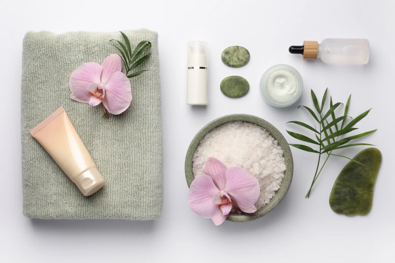 Flat lay composition with different spa products on white background